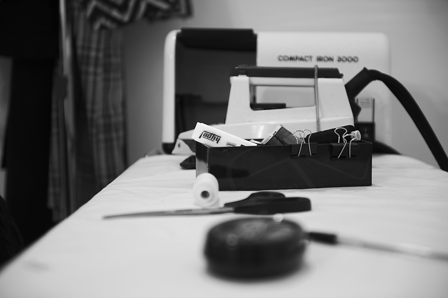 black and white stylist reportage image captured moment of sowing kit in narrative fashion tell a story 6