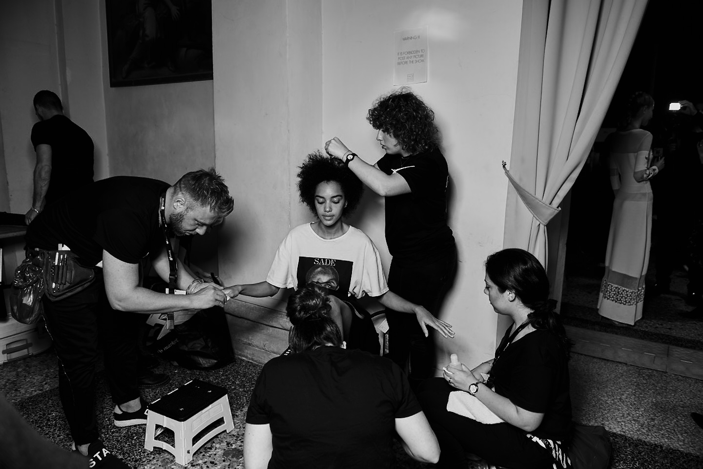 model prepares backstage black and white hair styling manicure reportage tell a story 28